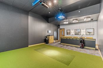A room with a green floor and grey walls.
